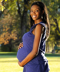 Picture of pregnant woman holding her baby bump.